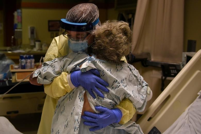Healthcare personnel prepare to discharge a patient who had been quarantining after a possible exposure to the coronavirus at a hospital in Lakin, Kansas, November 19, 2020. REUTERS/Callaghan O'Hare
